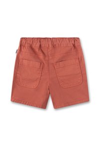 Rust-colored shorts with a textured fabric, elastic waistband, and two large back pockets. Simple design, knee-length cut.