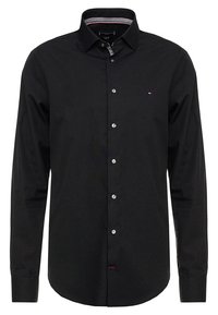 Black long-sleeve shirt made from cotton, featuring a button-down collar, front buttons, and a small logo on the chest. Simple design.