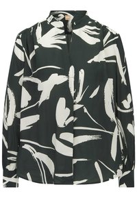 Blouse vert foncé avec des motifs abstraits en rayures blanches, dotée d'un col montant, d'épaules plissées et de manches longues avec des poignets boutonnés.