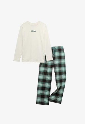 T-shirt à manches longues blanche avec le texte "RESET" associé à un pantalon de pyjama à cordon de serrage à carreaux turquoise, noir et gris.