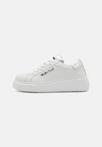 White leather sneakers with a slight platform sole, silver accents on the heel, and logo detail on the side. Smooth texture, round toe design.