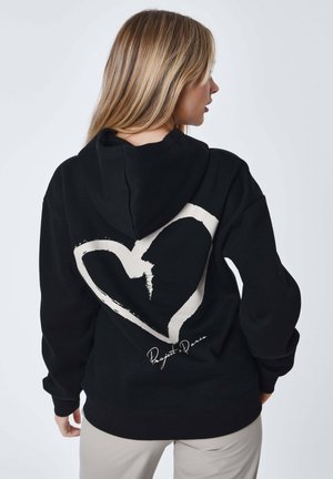 Felpa nera con cappuccio in cotone con grande grafica a cuore bianco e scritta "Project Paris" sul retro. Dotata di tasca frontale a marsupio e cappuccio.
