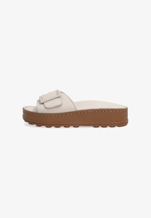 Lys beige slidesandal med et bredt bånd og en dekorativ spænde, der har en tyk brun platformssål med teksturerede greb.
