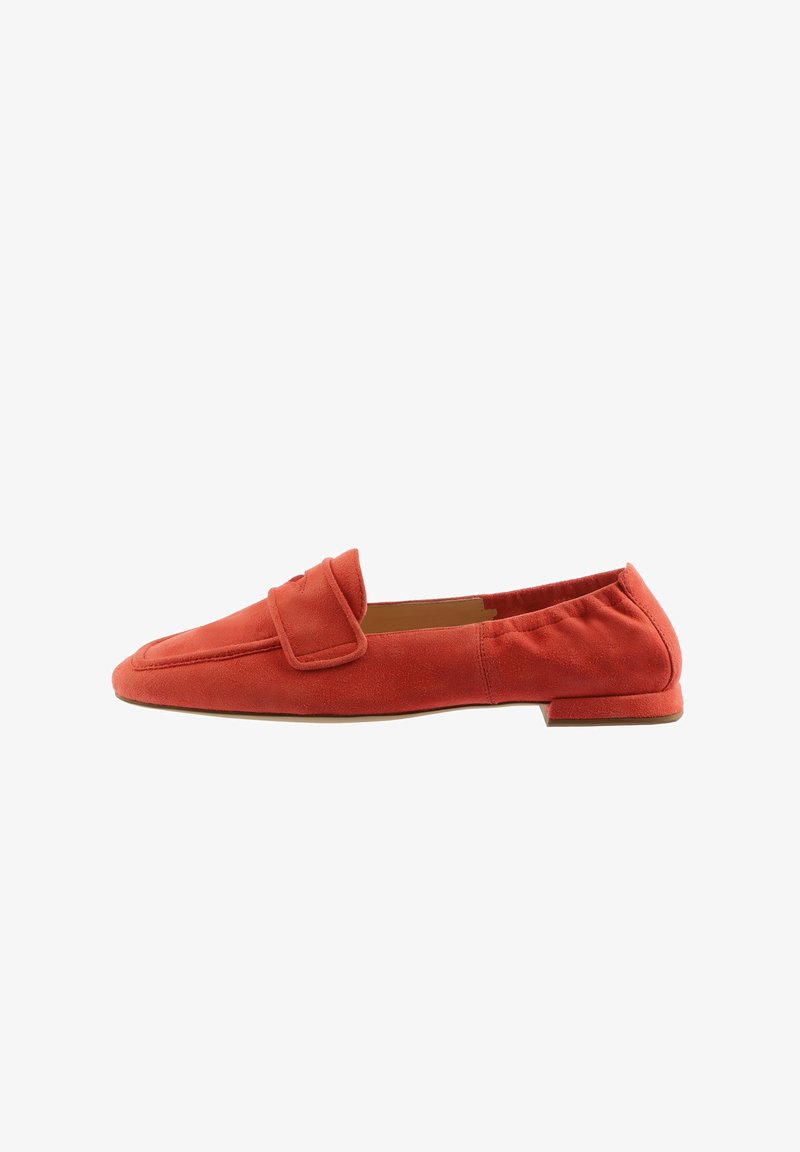 Red suede loafers with a flat heel, featuring a decorative strap across the upper and a smooth, minimalist design.
