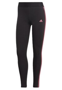 Svarta leggings med en figurnära design och en mjuk textur samt rosa sidremsor. Adidas-logotypen syns på framsidan av höften.