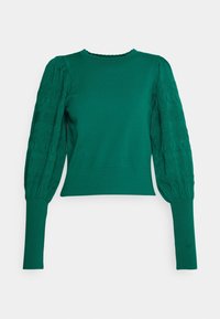 Pull vert avec manches bouffantes texturées. Corps lisse avec poignets côtelés et encolure festonnée. Tissu léger et coupe ajustée.