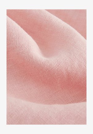 Tessuto rosa chiaro con trama testurizzata, che presenta un aspetto morbido e leggermente stropicciato, evidenziando la sua qualità leggera e traspirante.