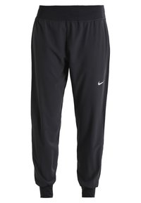 Pantalon de sport noir en tissu léger, avec une large ceinture élastique, des jambes fuselées, et un petit logo argenté sur le côté gauche.