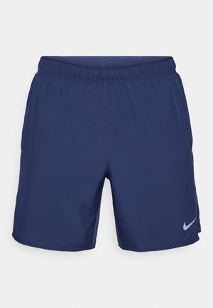 Navy athletic shorts with an elastic waistband, side pockets, and a small silver Nike logo on the left leg. Smooth, lightweight material.