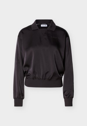 Juodas ilgomis rankovėmis satino polo marškinėlis su ribotais rankogaliais ir apačia, su subtiliu siuvinėtu logotipu krūtinės srityje.