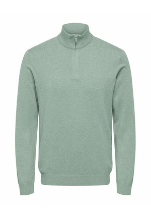 Helesinine rohelise tooniga kampsun kõrge kraega, poollukuga, soonikkoes allääre ja varrukatega. Pehme tekstuur, pikad varrukad, minimalistlik disain.