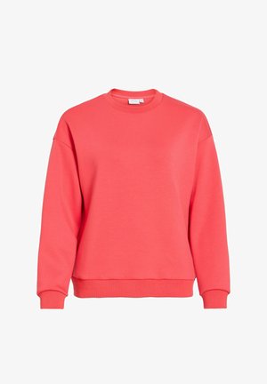 Koraalrode trui met een ronde hals, afgezakte schouders en geribbelde boorden. Zachte stof en een losse pasvorm. Geen patronen of versieringen.