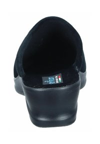 Black suede slip-on shoe with a rounded back and a slight heel. Interior features a label with blue and red accents.