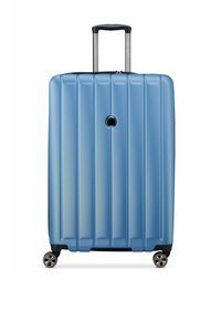 Valise rigide de couleur bleu clair avec une texture à rainures verticales, une poignée rétractable, quatre roues doubles pivotantes, et un trou de verrouillage circulaire.