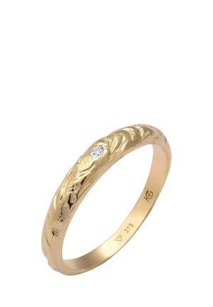 Gold ring with a textured, wavy design and a small, clear gemstone. Features a polished interior and markings inside the band.