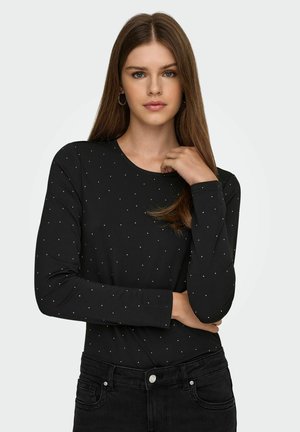 Zwarte lange mouw top met een ronde hals, voorzien van zilveren metallic stipaccenten. Glad textuur, aansluitend ontwerp, gecombineerd met donkere jeans.