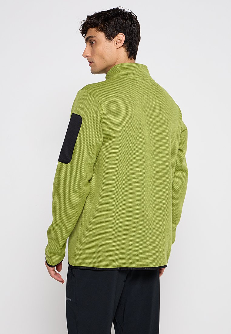 Grüne strukturierte Jacke mit schwarzen Schulterakzenten und hohem Kragen, im lässigen Schnitt mit flachen Nähten.