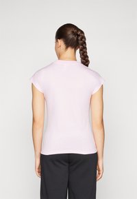 T-shirt de manga curta rosa claro com decote redondo e forma ajustada, feito de um tecido macio e elástico, mostrado pela parte de trás.