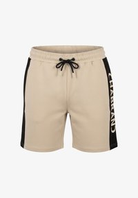 Pantalones cortos beige con paneles laterales negros, cintura elástica, cordón negro y texto blanco "CHABRAND" en el panel lateral derecho.