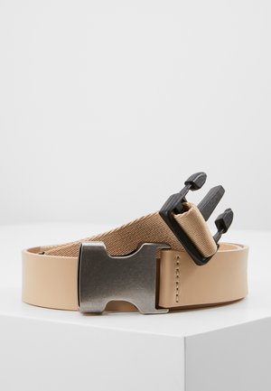 Beige belt with metal buckle and black plastic quick-release clasp on a white surface against a light gray background.