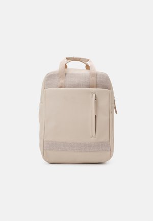 Sac à dos rectangulaire beige avec section supérieure texturée, poche avant verticale zippée et deux poignées courtes sur le dessus, sur fond blanc.