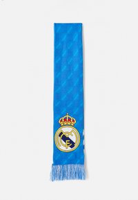 Královsky modrý šál s logom Real Madrid a korunou, vyrobený z mäkkej tkaniny, s strapcami a jemnými diamantovými vzormi.