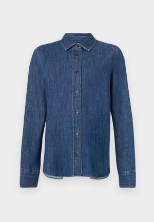 Mørkeblå denimskjorte med lange ermer, knappefront, klassisk krave og synlige sømmer. Har en rett kant med en lett kurve i sidene.