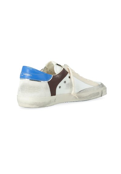Sneaker bianchi bassi con lacci beige, pannello laterale marrone, linguetta blu sul tallone e suola consumata e graffiata.