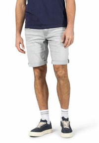 Light gray denim shorts with rolled cuffs, featuring a classic 5-pocket design. Worn with navy sneakers and white athletic socks.