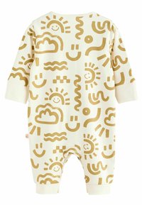 Cream-colored onesie featuring golden abstract patterns of suns, clouds, and wavy lines; long sleeves and ankle cuffs.