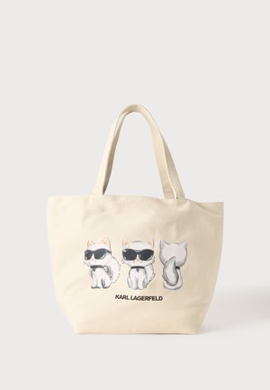Beige mulepose med tre tegneseriekatte iført sorte solbriller og butterfly, med teksten "KARL LAGERFELD" under kattene.
