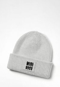 Gray knitted beanie with a ribbed texture. Features a folded cuff and a rectangular patch with "Mini Boss" in bold black lettering.