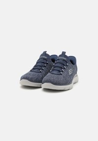 Navy athletic shoes with a textured knit upper and elastic laces, featuring a cushioned white sole and logo detail on the side.