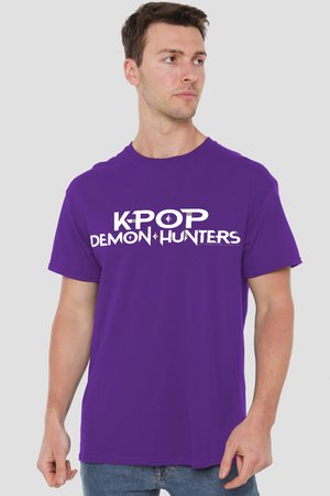 Man in purple t-shirt with white text "K-POP DEMON HUNTERS" looking to the side against a plain gray background.