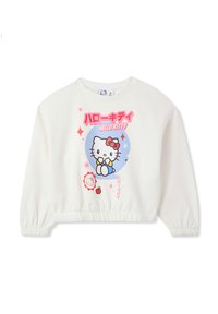 Felpa bianca corta con polsini arricciati, caratterizzata da una grafica colorata di "Hello Kitty" e testo giapponese. Tessuto morbido, stile casual.
