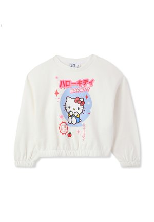 Felpa bianca corta con polsini arricciati, caratterizzata da una grafica colorata di "Hello Kitty" e testo giapponese. Tessuto morbido, stile casual.