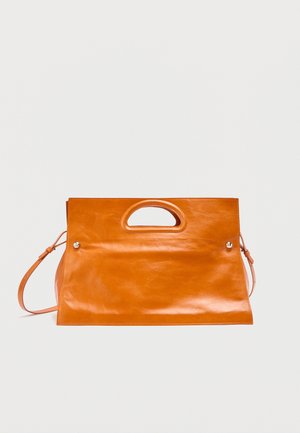 Rectangular orange leather handbag with built-in handle cutout and adjustable shoulder strap on plain background.