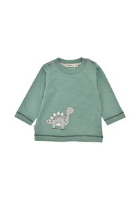 Maglietta verde a maniche lunghe realizzata in un tessuto morbido, con applicazione di un dinosauro grigio e cuciture a contrasto lungo il fondo e le maniche.