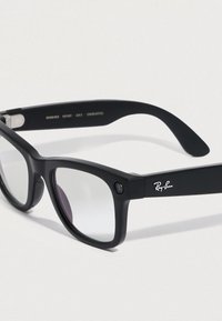 Ray-Ban Sonnenbrille mit mattschwarzem Kunststoffrahmen, rechteckiger Form und klaren Gläsern. Verfügt über ein silbernes Logo am Bügel und eine Kamera auf der Vorderseite.