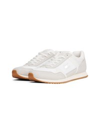 Gray and white sneakers with a suede upper, flat laces, and a grippy gum sole. Features a rectangular logo accent on the side.