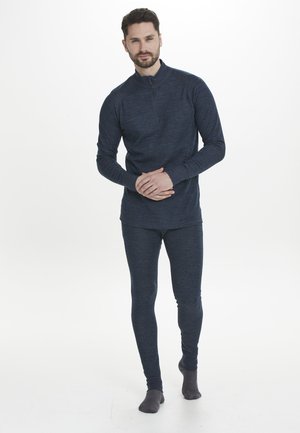 Marinekleurige thermoshirt met een halve rits kraag en lange mouwen, gecombineerd met bijpassende, aansluitende leggings. Zachte textuur door het gehele kledingstuk.