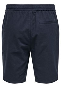 Mørkeblå shorts laget av bomull, med elastisk midjebånd og en enkel baklomme med en liten logodetalj. Jevn tekstur.