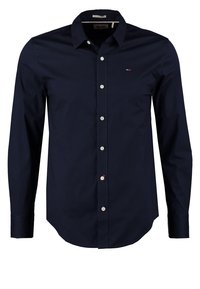 Navy blue button-up shirt with a classic collar, long sleeves, and a small logo on the chest; made of smooth, woven fabric.