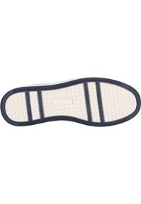 Shoe sole features a textured white rubber base with a navy blue edge; includes horizontal and vertical traction grooves. Hexagonal pattern present.