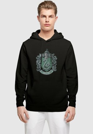 Black hoodie featuring a Slytherin crest design in green and silver with detailed snake and decorative elements. Kangaroo pocket at the front.