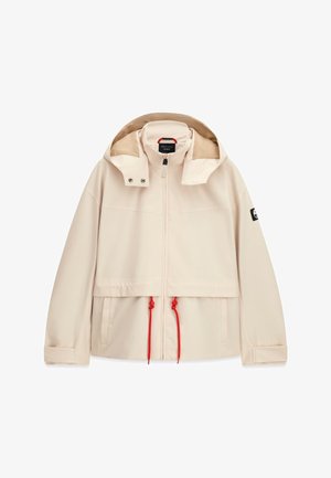 Veste beige à capuche avec fermeture éclair devant, cordons rouges réglables à la taille, poches latérales, poignets en velcro et écusson de marque sur la manche gauche.