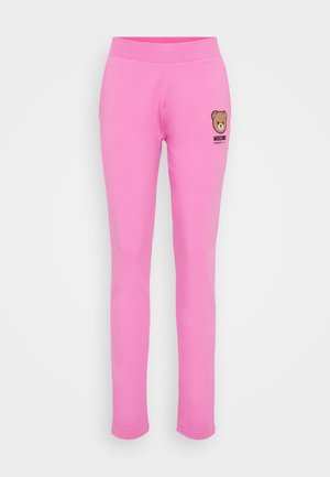 Roosa puuvillased retuusid pehme tekstuuriga, millel on karu graafika ja "Moschino" logo vasakul küljel, mõeldud igapäevaseks kandmiseks.