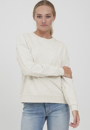Lys beige genser med en avslappet passform, med lange ermer og rund hals. Laget av mykt, teksturert stoff med subtile variasjoner.