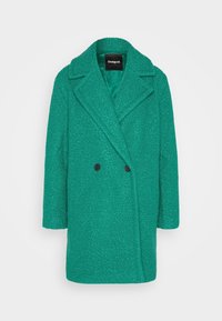 Manteau croisé en mélange de laine texturé vert avec de larges revers et deux boutons noirs, présenté sur un fond blanc uni.