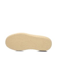 Sola di scarpa in gomma beige con un motivo testurizzato, forma arrotondata e leggera curvatura nel tallone. Dettaglio del logo inciso vicino al bordo inferiore.